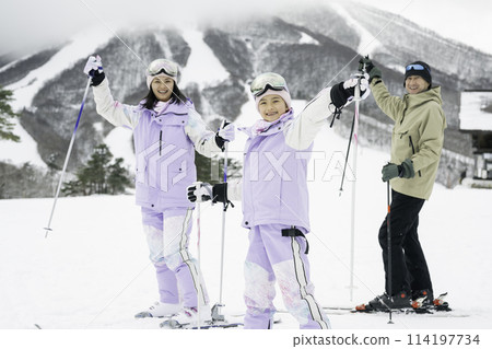 Family, parents and daughter enjoying skiing on snowy mountain Family, parents and daughter enjoying skiing on snowy mountain 114197734