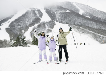 Family, parents and daughter enjoying skiing on snowy mountain Family, parents and daughter enjoying skiing on snowy mountain 114197760