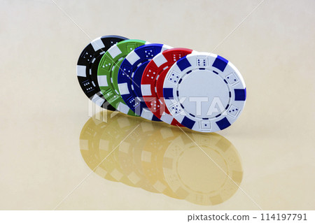 The mirrored surface reflects colorful casino chips 114197791