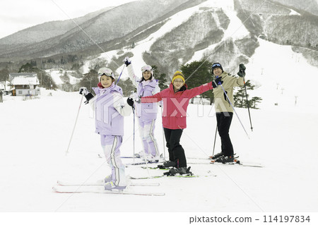 Family enjoying skiing on snowy mountain Family enjoying skiing on snowy mountain 114197834