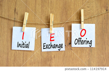 IEO initial exchange offering symbol. Concept words IEO initial exchange offering on beautiful paper. Beautiful wooden background. Business IEO initial exchange offering concept. Copy space. 114197914