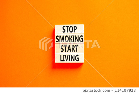 Stop smoking start living symbol. Concept words Stop smoking start living on cubes. Beautiful orange background. Medical healthy lifestyle stop smoking start living concept. Copy space. Stop smoking start living symbol. Concept words Stop smoking start living on cubes. Beautiful orange background. Medical healthy lifestyle stop smoking start living concept. Copy space. 114197928