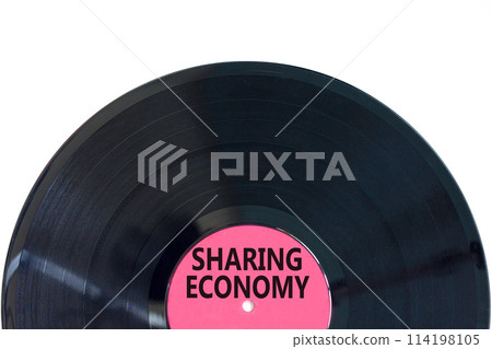 Sharing economy symbol. Concept words Sharing economy on beautiful black vinyl disk. Beautiful white table white background. Business sharing economy concept. Copy space. 114198105