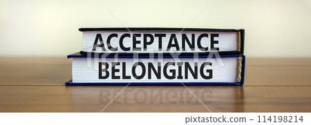 Acceptance and belonging symbol. Books with words 'acceptance and belonging' on beautiful wooden table, white background. Business, acceptance and belonging concept. Copy space. 114198214