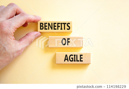 Benefits of agile symbol. Concept words Benefits of agile on beautiful wooden blocks. Beautiful white table white background. Businessman hand. Business benefits of agile concept. Copy space. 114198229
