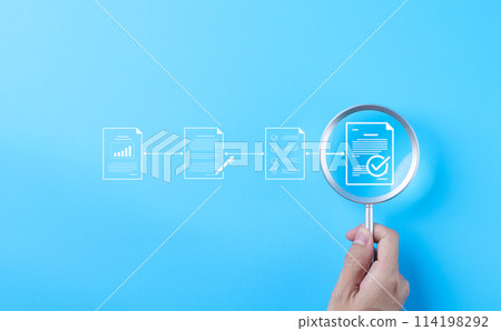 Document review process and quality control concept. Hand holding magnifying glass over a document icon with checklist, Document review and approval. Certificate management, Audit, Standardization, 114198292