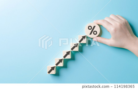 Interest rate and dividend concept. Arranging wooden blocks with arrows and a percentage sign. Business finance and money, Investment growth, Return on stock, mutual fund, Increased profitability, 114198365