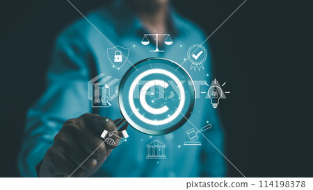 Digital copyright or patent concept. Author rights and patented intellectual property. Businessman holding a magnifying glass focuses on a copyright symbol surrounded by legal icons. trademark license 114198378