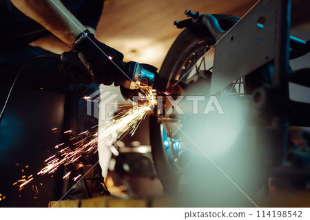 Motorcycle repair. Disassembled motorcycle. Fixing motorcycle standing in repair shop. Instruments. Motorcycle repair. Disassembled motorcycle. Fixing motorcycle standing in repair shop. Instruments. 114198542