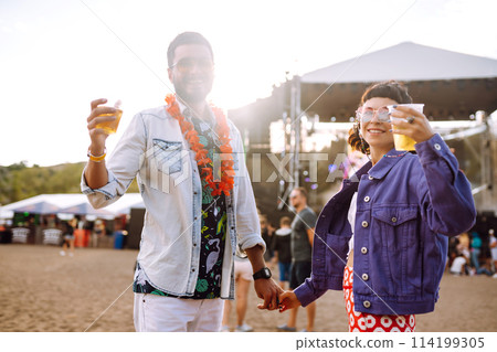 Group of friends with beer dancing and having fun at music festival together. Summer Beach party. 114199305