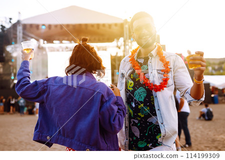 Group of friends with beer dancing and having fun at music festival together. Summer Beach party. Group of friends with beer dancing and having fun at music festival together. Summer Beach party. 114199309