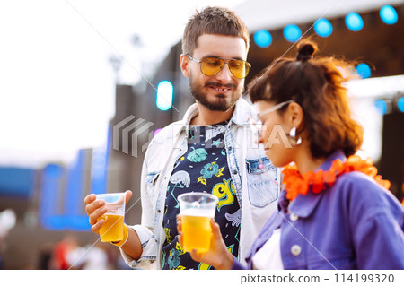 Group of friends with beer dancing and having fun at music festival together. Summer Beach party. 114199320