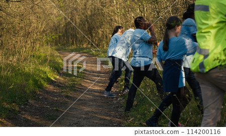 As the mission for the lost individual grows worse, supervisor of the rescue operation team guides his crew into the forest in search of clues. People screaming for missing person's name. Camera A. 114200116