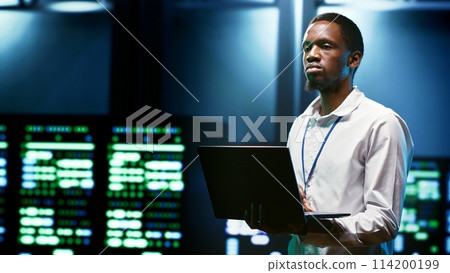 IT developer setting up data center advanced firewalls, intrusion detection systems and regular security updates. Cybersecurity expert preventing hacking, malware, and DDoS attacks 114200199