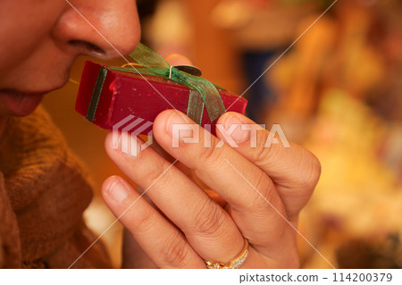 woman taking smell from a natural soap bar 114200379