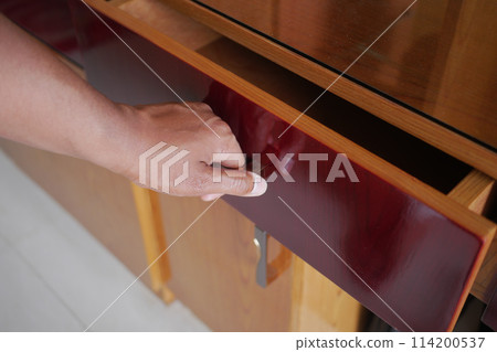 top view of men hand open a a drawer top view of men hand open a a drawer 114200537