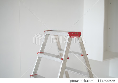 Metal ladder standing in empty room, renovation and improvement concept. Metal ladder standing in empty room, renovation and improvement concept. 114200626