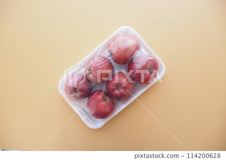 apples wrapped in transparent plastic. apples wrapped in transparent plastic. 114200628