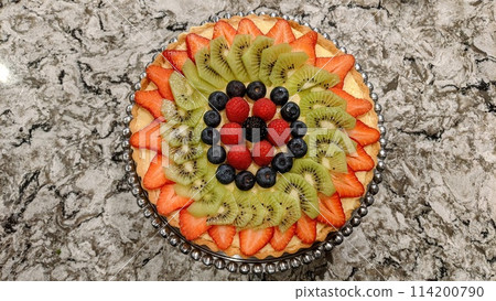 Vibrant Homemade Fruit Tart with Fresh Berries on Granite Counter Vibrant Homemade Fruit Tart with Fresh Berries on Granite Counter 114200790