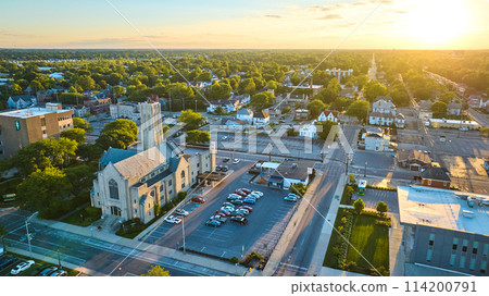 Church in Midwest town at sunset with golden glow and neighborhood, Muncie, IN aerial 114200791