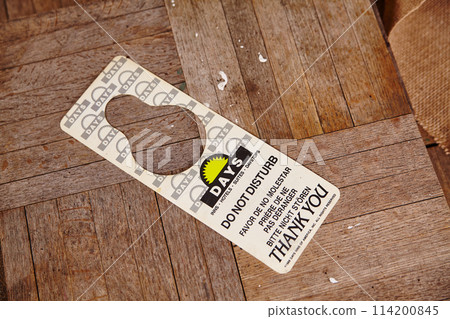 Worn Do Not Disturb Sign on Wooden Surface 114200845
