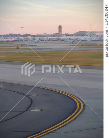 Sunset at Busy Airport with Taxiway and Aircraft on Ground 114200847