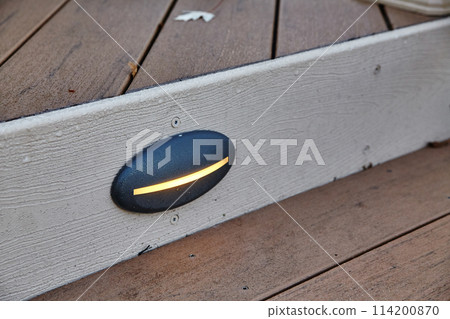 Modern Outdoor Wall Light on Wooden Siding, Warm Glow at Dusk 114200870