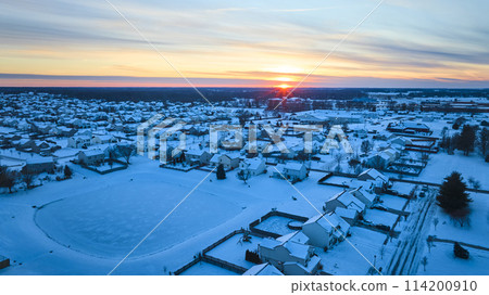 Aerial Winter Sunrise Over Snowy Suburban Neighborhood 114200910