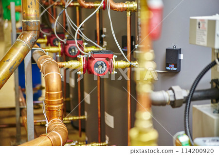 Industrial Copper Piping with Red Valve Close-Up Industrial Copper Piping with Red Valve Close-Up 114200920