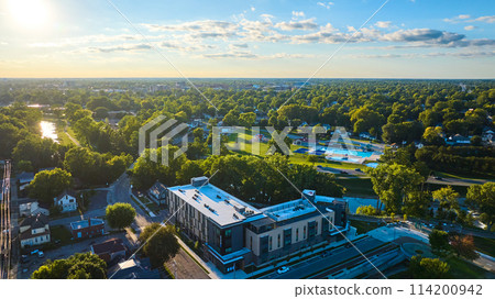 Apartment building aerial Muncie, IN with Tuhey Pool on other side of White River in late afternoon 114200942