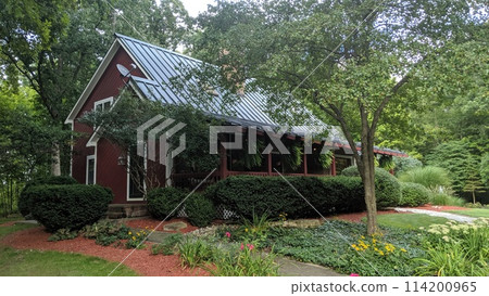 Red House with Metal Roof in Lush Landscape, Eye-Level View 114200965