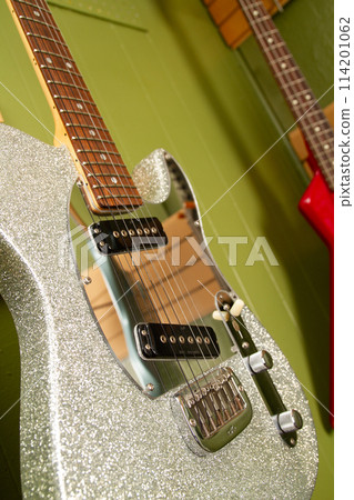 Close-Up of Silver Sparkling Electric Guitar in Music Studio Setting 114201062