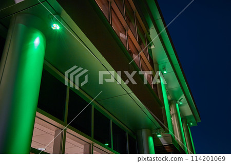 Green Illuminated Modern Building in Night Time Urban Landscape 114201069
