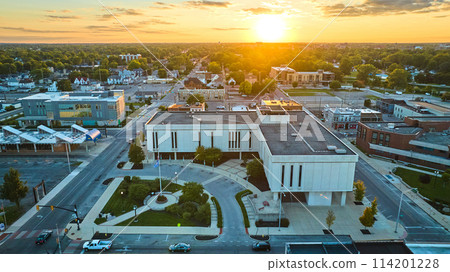 Delaware County Court Administration with golden sun setting on horizon aerial of Muncie city, IN Delaware County Court Administration with golden sun setting on horizon aerial of Muncie city, IN 114201228