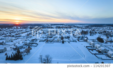 Aerial Winter Sunset Over Snowy Suburban Neighborhood 114201307