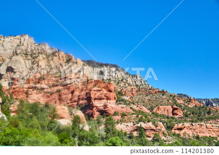 Sedona Red Rock Cliffs and Lush Foliage Under Blue Sky 114201380
