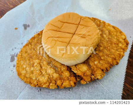 Oversized Fried Chicken Sandwich on Parchment - Top View Oversized Fried Chicken Sandwich on Parchment - Top View 114201423