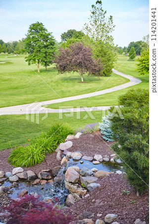 Serene Golf Course Landscape with Cascading Stream and Garden Feature 114201441