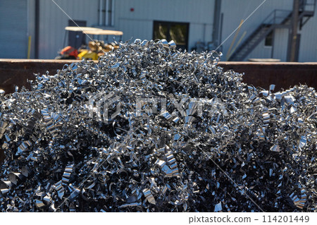 Industrial Scrap Metal Pile with Machinery Background Industrial Scrap Metal Pile with Machinery Background 114201449