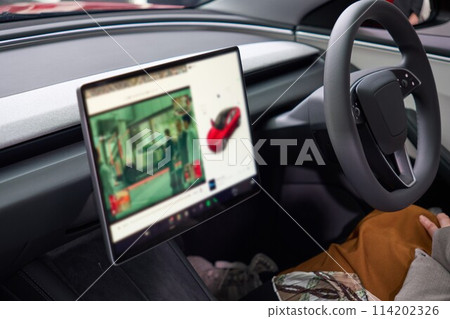 The interior of an autonomous vehicle equipped with a large display 114202326