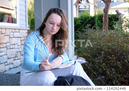 Young male student writes information from portable net-book while prepare for lectures in University campus, hipster man working on laptop computer while sitting in cafe,vintage color,selective focus Young male student writes information from portable net-book while prepare for lectures in University campus, hipster man working on laptop computer while sitting in cafe,vintage color,selective focus 114202446