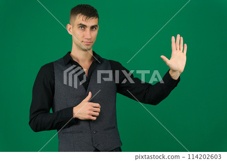spy emotions of a handsome man guy on a green background chromakey close-up dark hair young man spy emotions of a handsome man guy on a green background chromakey close-up dark hair young man 114202603