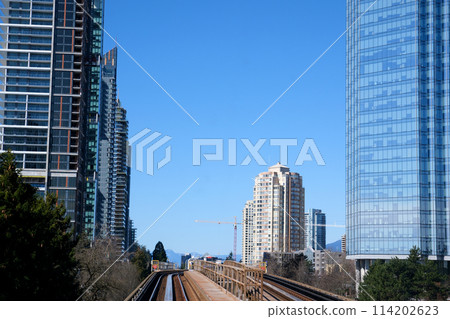 sky train road from Surrey to Vancouver passing trains skyscrapers office buildings science center and other stations from King George to Waterfront real life in a big city british columbia 2023 114202623