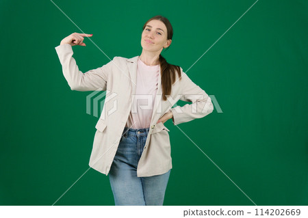 Girl in jeans shirt isolated on green background Girl in jeans shirt isolated on green background 114202669