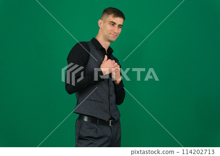 Hansome Young man in suit over emotions of a handsome man guy on a green background chromakey close-up dark hair young man Hansome Young man in suit over emotions of a handsome man guy on a green background chromakey close-up dark hair young man 114202713