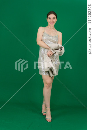 Fashion woman in evening dress portrait. Female young model. Studio isolated , green background .Long hair. 114202808
