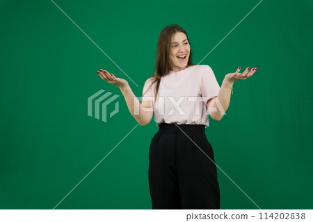 Portrait of careless young woman shrugging shoulders and smiling background. Caucasian lady wearing black T-shirt expressing indifference. Bewilderment concept 114202838