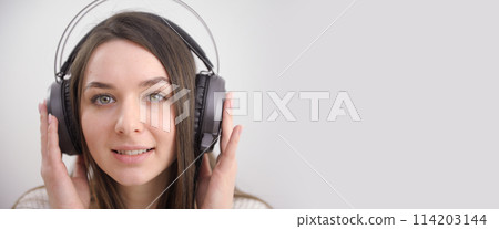 Girl with headphones on white background. Isolated on white. Girl with headphones on white background. Isolated on white. 114203144