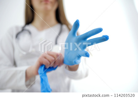 doctor or nurse wearing protective rubber gloves on white background with copy space. Health care concept 114203520