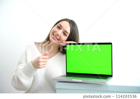 Young woman holding laptop with success 114203536